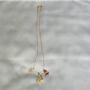 Kate Spade Gold Tone Necklace With Skate, Mitten & Crystal Snowflake Charm.